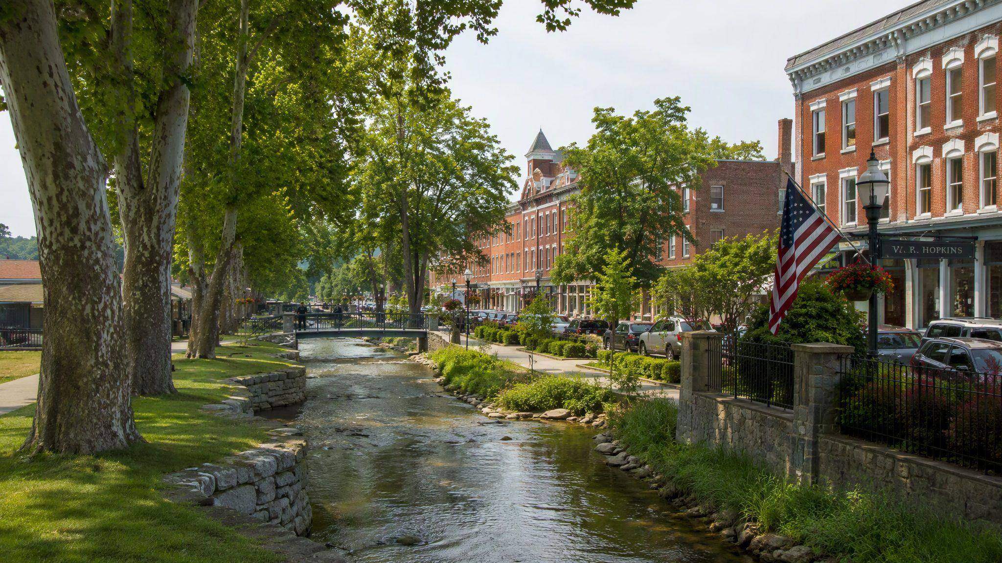 Sager Creek flowing past brick storefronts in downtown Siloam Springs, Arkansas